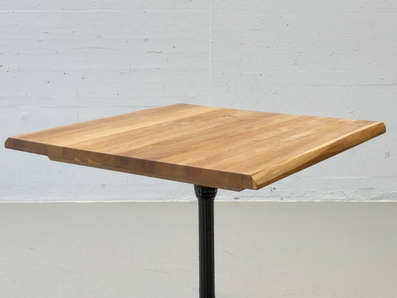 Image 1 of Bistro table made of acacia wood with a cast iron base in country style