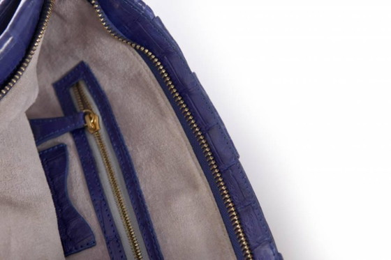 Image 1 of Nancy Gonzales, pochette in morbida pelle di coccodrillo color blu cobalto.