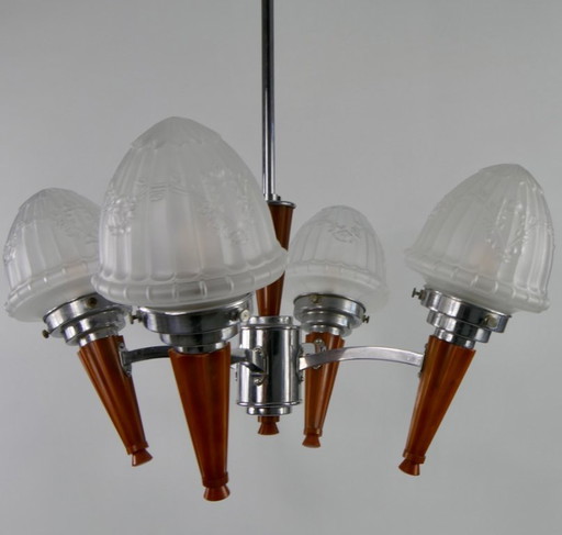 Chrome Art Deco chandelier with four amber Bakelite torches with decorated glass lampshades, ca. 1935