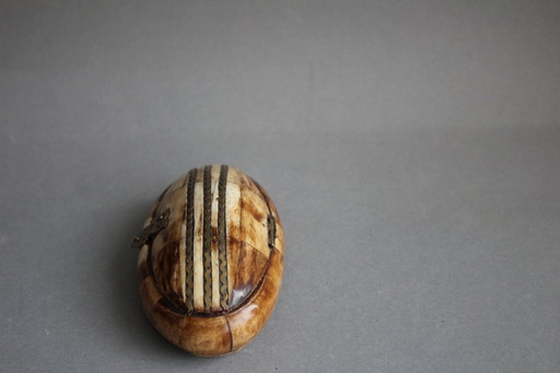 Vintage jewelry box made of horn or bone with brass decoration on the lid.