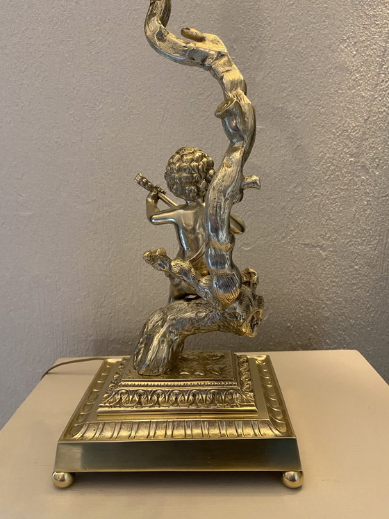 Image 1 of Bronze table lamp depicting a cherub playing the guitar