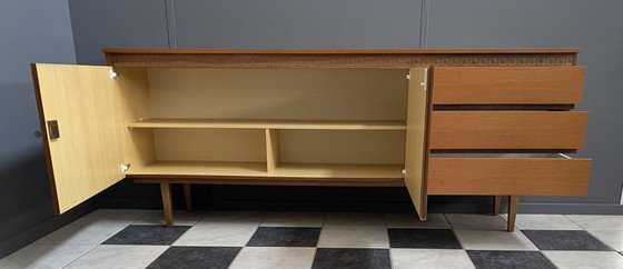 Image 1 of Dressoir uit de jaren 70 met decoratieve lijn boven de deuren.