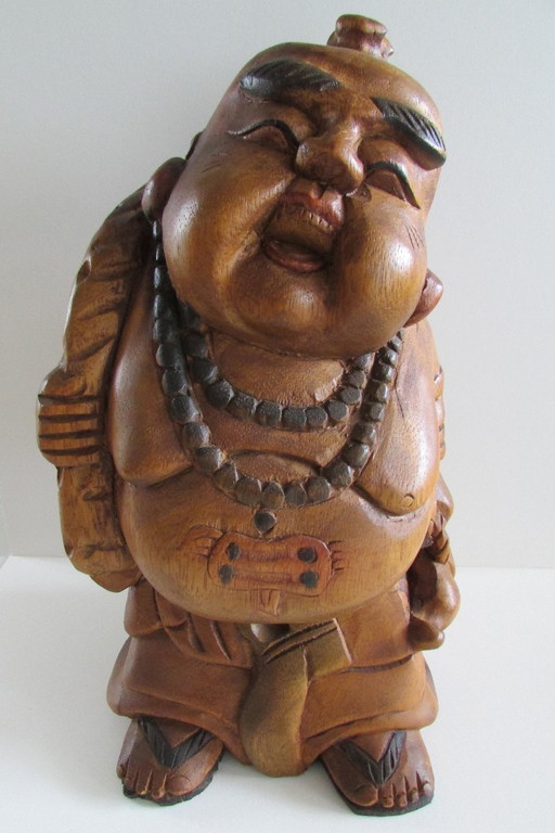 Hand-carved wooden statue of the Laughing Buddha