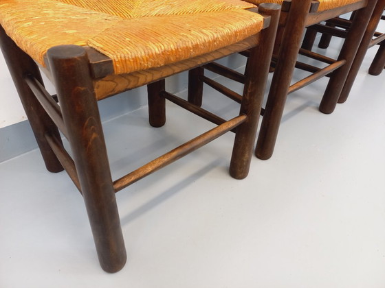 Image 1 of Set van 4 vintage brutalistische stoelen van Georges Robert, gemaakt van hout en stro, uit de jaren 50 en 60.