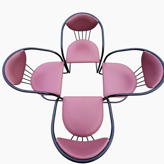 Image 1 of This is a set of four vintage 'Memphis' style chairs with a black metal frame and burgundy upholstery.