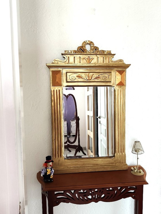 Image 1 of Gilded wooden mirror with carved pediment in the trumeau style