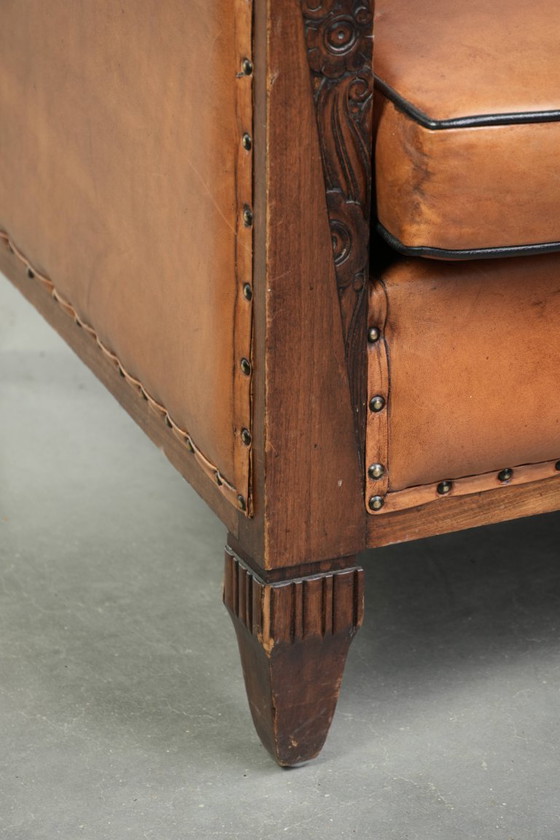 Image 1 of Unieke schapenleren art Deco fauteuil met mooi houtsnijwerk en zwarte biezen