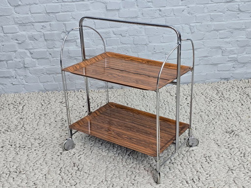 Vintage Design Foldable and Mobile Chrome Steel 2 Faux Wood Layers ‘Dinett’ Serving Trolley by Gerlinol, Germany, 1970s. 