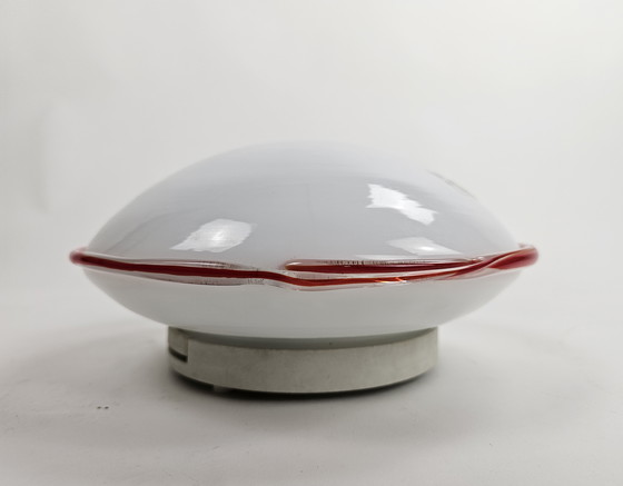Image 1 of Ceiling or wall lamp by Leucos Italian milk glass discus model with red rim