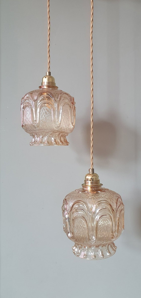 Image 1 of Set of 2 Vintage textured rose / amber tinted pendant lamps - mid-century design.