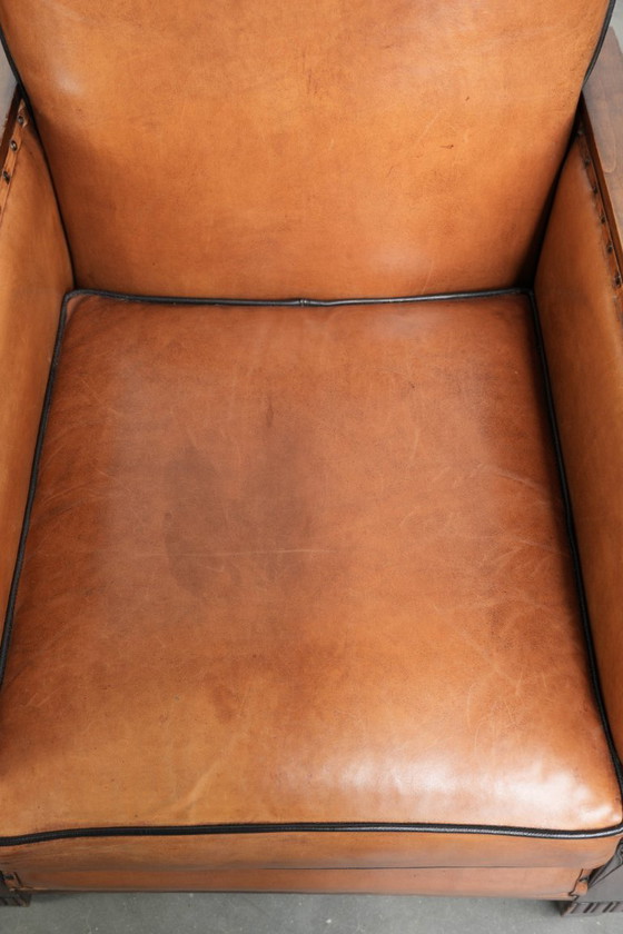Image 1 of 2 x Prachtige schapenleren Art Deco fauteuil met mooi houtsnijwerk en zwarte biezen