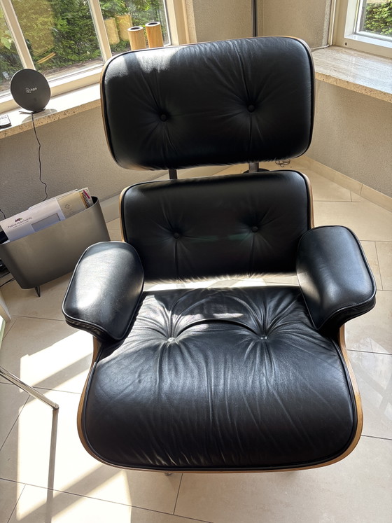 Image 1 of 2 x leather Eames armchairs with ottoman (replica)