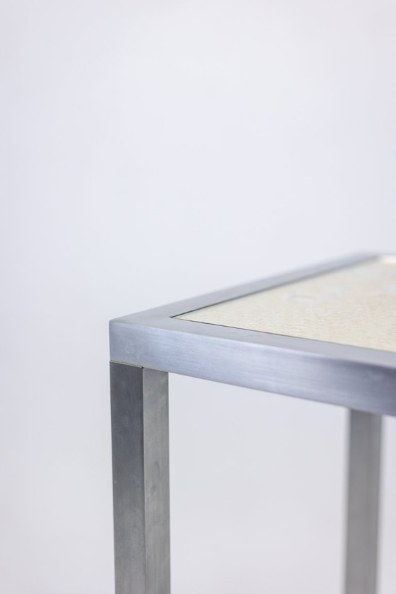 Image 1 of Maison Jansen. Consolle in alluminio spazzolato con piano in vetro verniciato a rovescio. 1970