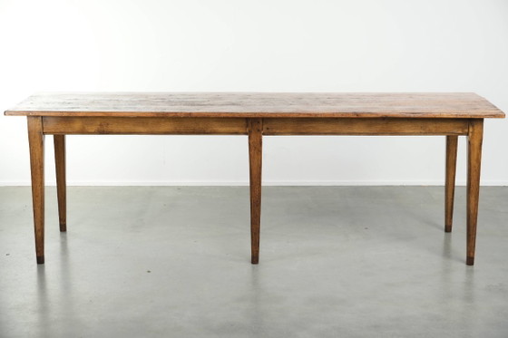Image 1 of Large, relatively narrow antique French farmhouse dining table made of pine from the early 19th century with a beautiful patina.