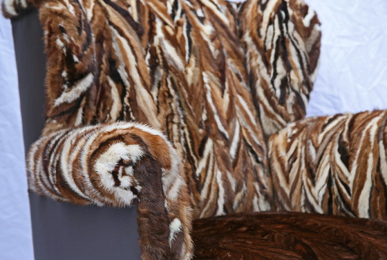 Image 1 of Antieke oorfauteuil met hergebruikte bontjassen bekleed (1910) 