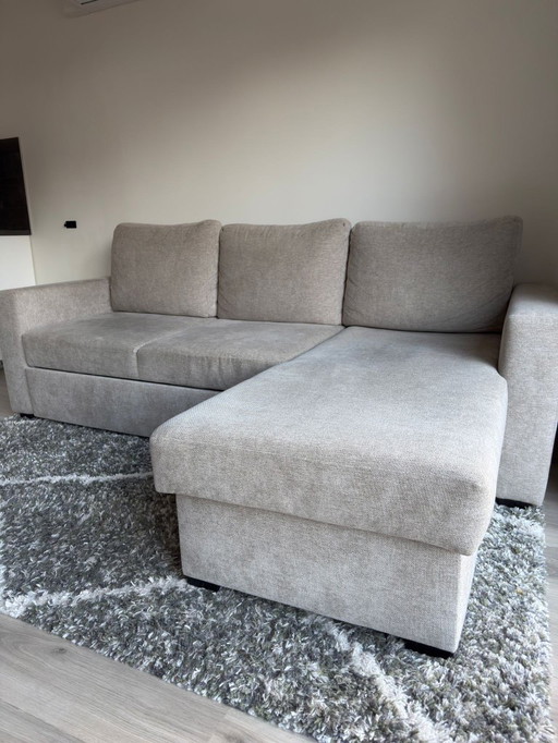 Corner sofa with storage space and sleeping area