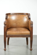 Antique armchair of sheepskin and wood with decorative nails and beautiful woodwork