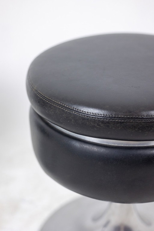Low cylindrical black stool with steel base. 1970s