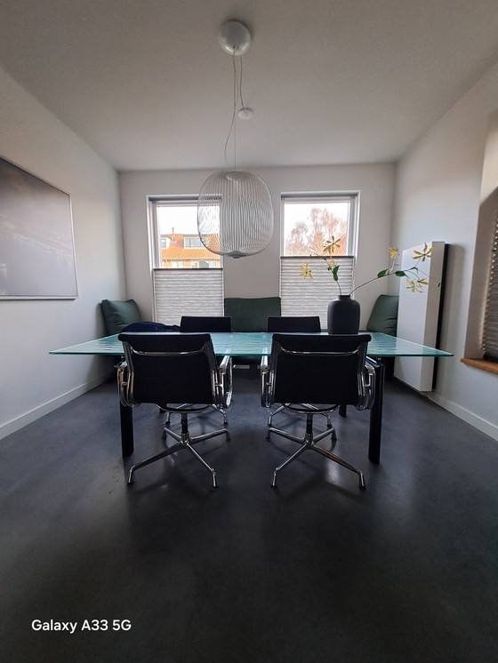 Image 1 of Beautiful combination of Cassina Le Corbusier table with frosted glass and 4 Vitra Eames chairs with black hupsakee upholstery 