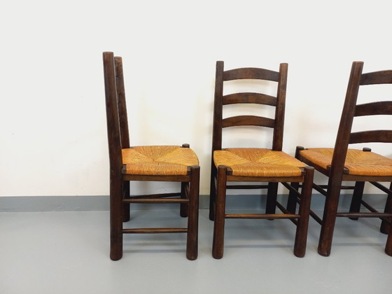 Image 1 of Set van 4 vintage brutalistische stoelen van Georges Robert, gemaakt van hout en stro, uit de jaren 50 en 60.