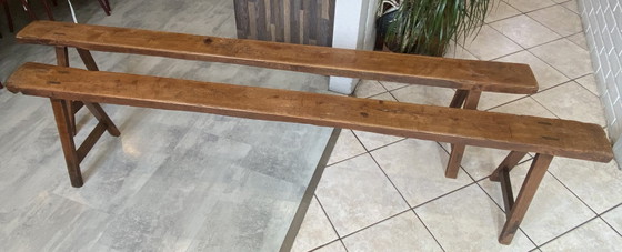 Image 1 of Twee massief eikenhouten boerenbanken van 214 cm voor een rustieke boerentafel uit de jaren 50.