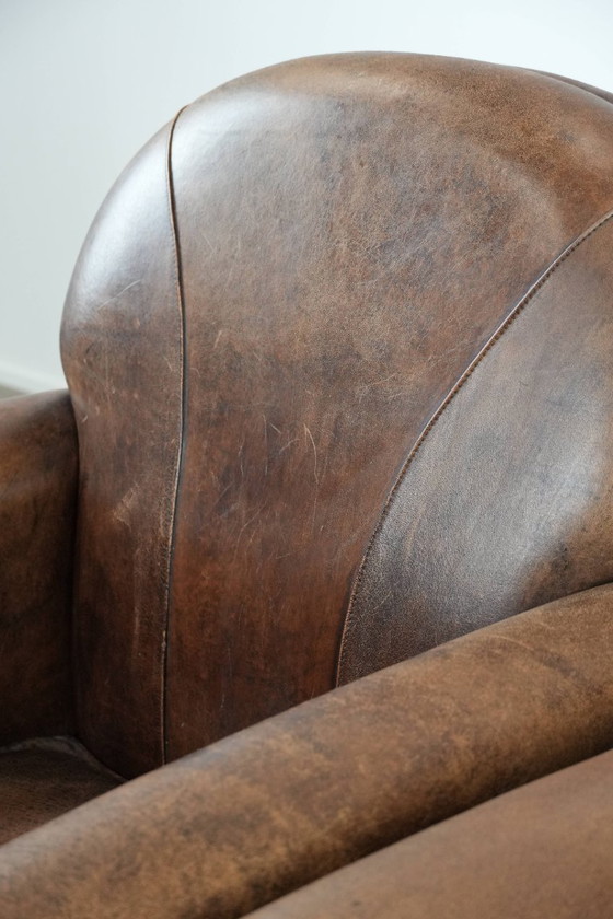 Image 1 of 2 x Vintage sheepskin armchair with warm colours and a characterful appearance