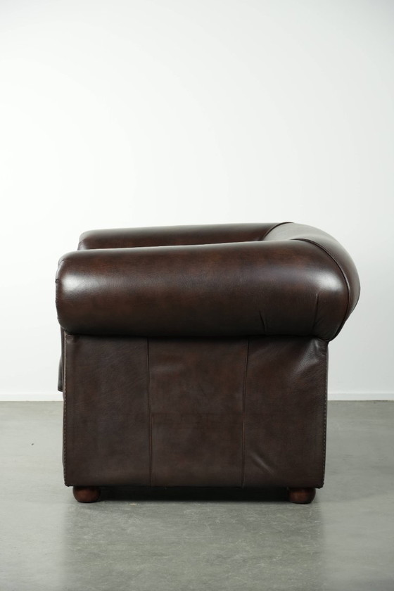 Image 1 of Conjunto de lujo de piel de vacuno marrón compuesto por un sofá Chesterfield liso y un sillón.