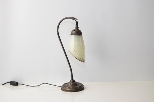 Vintage brass table lamp with curved arm and glass shade