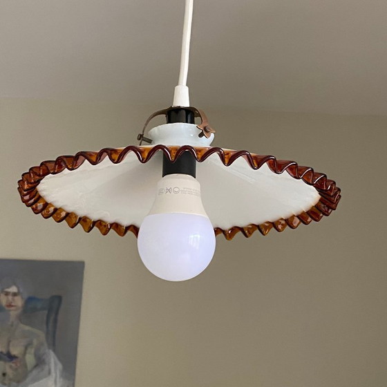 Image 1 of Antique pendant light with a white opaline glass shade and a golden caramel wavy edge