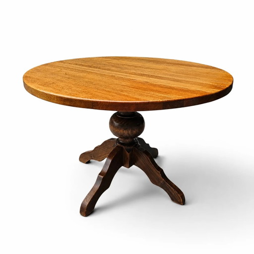 solid oak dining table / also known as a monastery table / with a sturdy central pedestal / Its heavy-duty construction