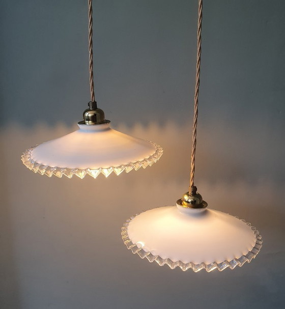 Image 1 of 2 vintage hanglampen van wit opaline glas met een transparante sierrand.