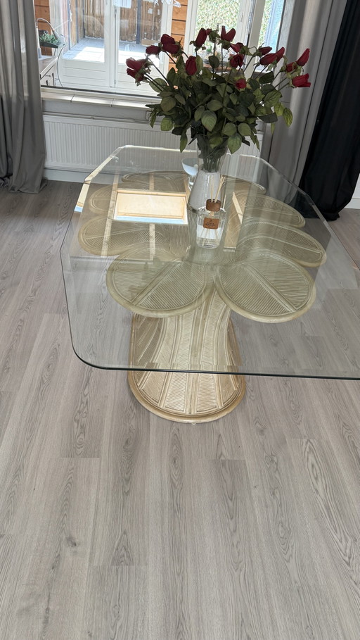 Beautiful glass dining table with a unique rattan base