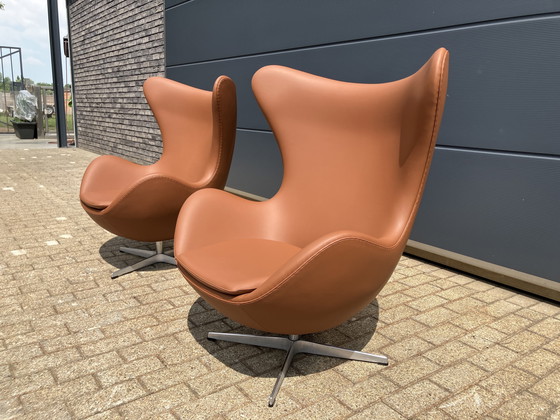 Image 1 of 2x Fritz Hansen Egg Chair + Ottoman en cuir Cognac NEUF !!!