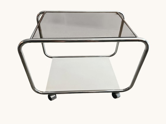 Image 1 of Vintage Space Age side table made of chrome and smoked glass. Sculptural 70s design with wheels.