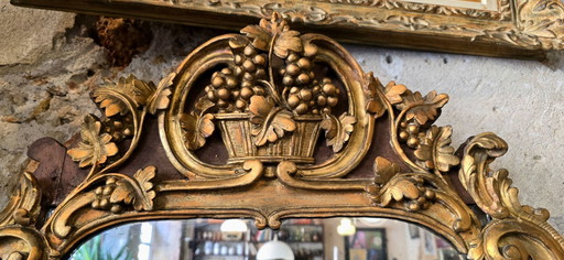Louis XV period mirror in gilded wood and 18th century stucco leaf