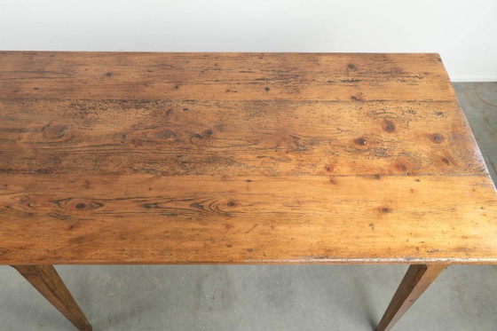 Image 1 of Large, relatively narrow antique French farmhouse dining table made of pine from the early 19th century with a beautiful patina.