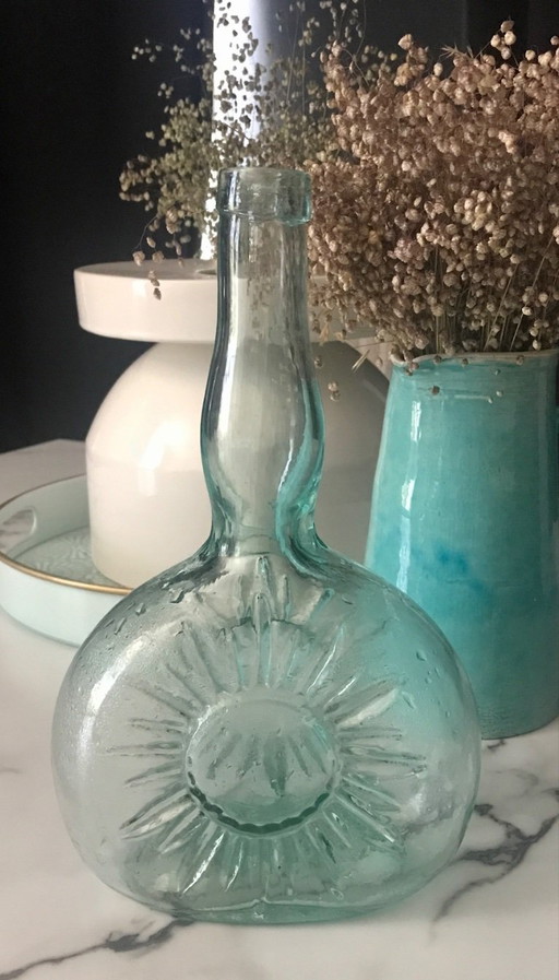 Sun-embossed bottle
