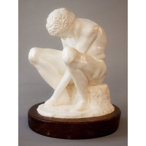 Sculpture of a seated man. Classical male sculpture. Male figure.