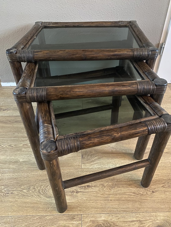 Image 1 of Vintage rattan bamboo nesting tables mimeset smoked glass