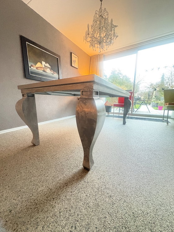 Image 1 of Zinc dining table with or without 8 leather chairs (Henders & Hazel) on wheels