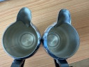 2 vintage Carlo Alessi stainless steel milk jugs with rounded tops and Bakelite handles.