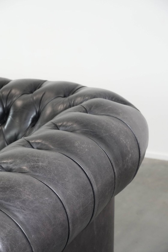 Image 1 of Set consisting of a black Chesterfield sofa, armchair and footstool made of cowhide