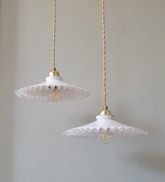 Image 1 of 2 vintage hanglampen van wit opaline glas met een transparante sierrand.