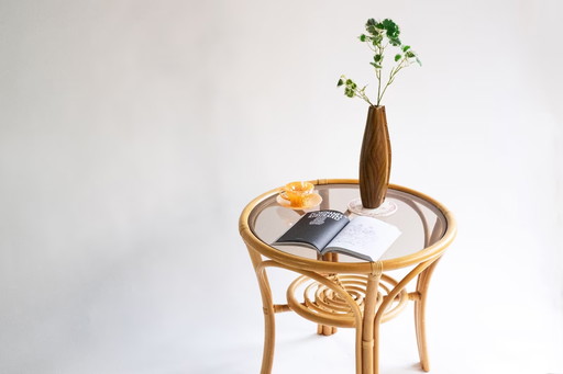 Elegant, round bamboo table with glass top