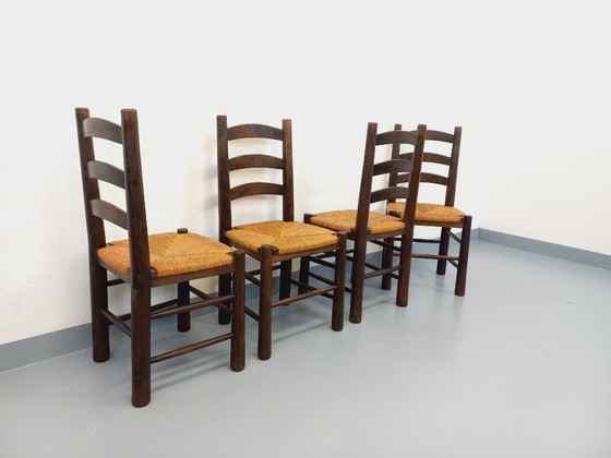 Image 1 of Set van 4 vintage brutalistische stoelen van Georges Robert, gemaakt van hout en stro, uit de jaren 50 en 60.