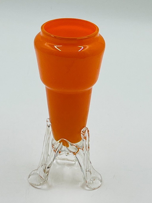 Vintage orange glass bud vase with a sculpted base