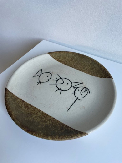Artistic ceramic decorative plate with a playful drawing