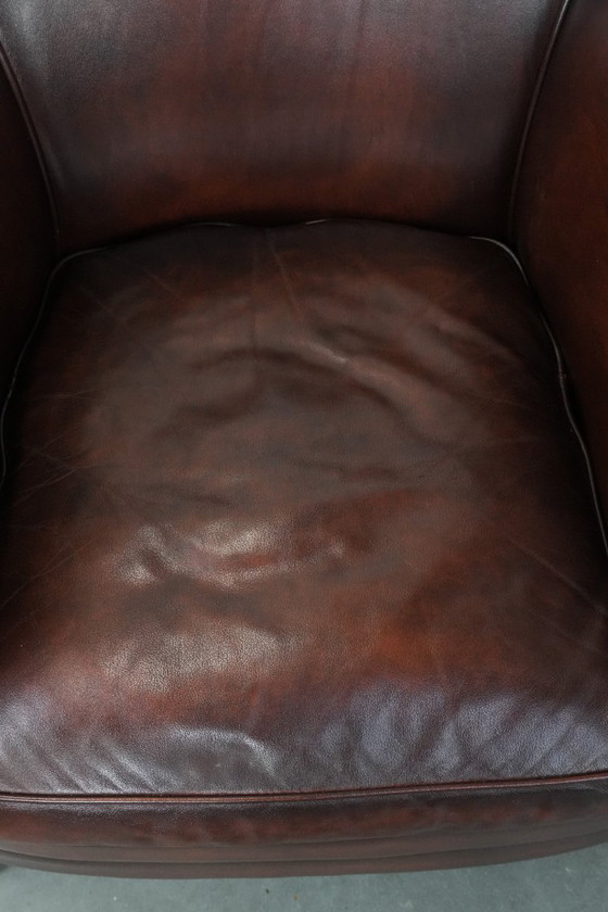 Image 1 of 2 poltrone club in pelle bovina in buone condizioni, di un lussuoso colore rosso/marrone.