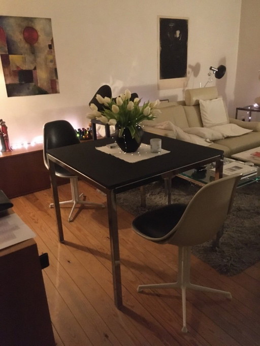 Modern dining table with chrome frame and black wood top