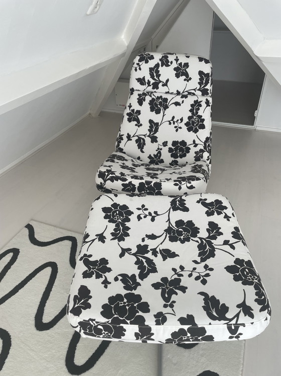 Image 1 of Black and white floral armchair with footstool
